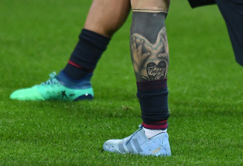 a person's leg with a tattoo on it