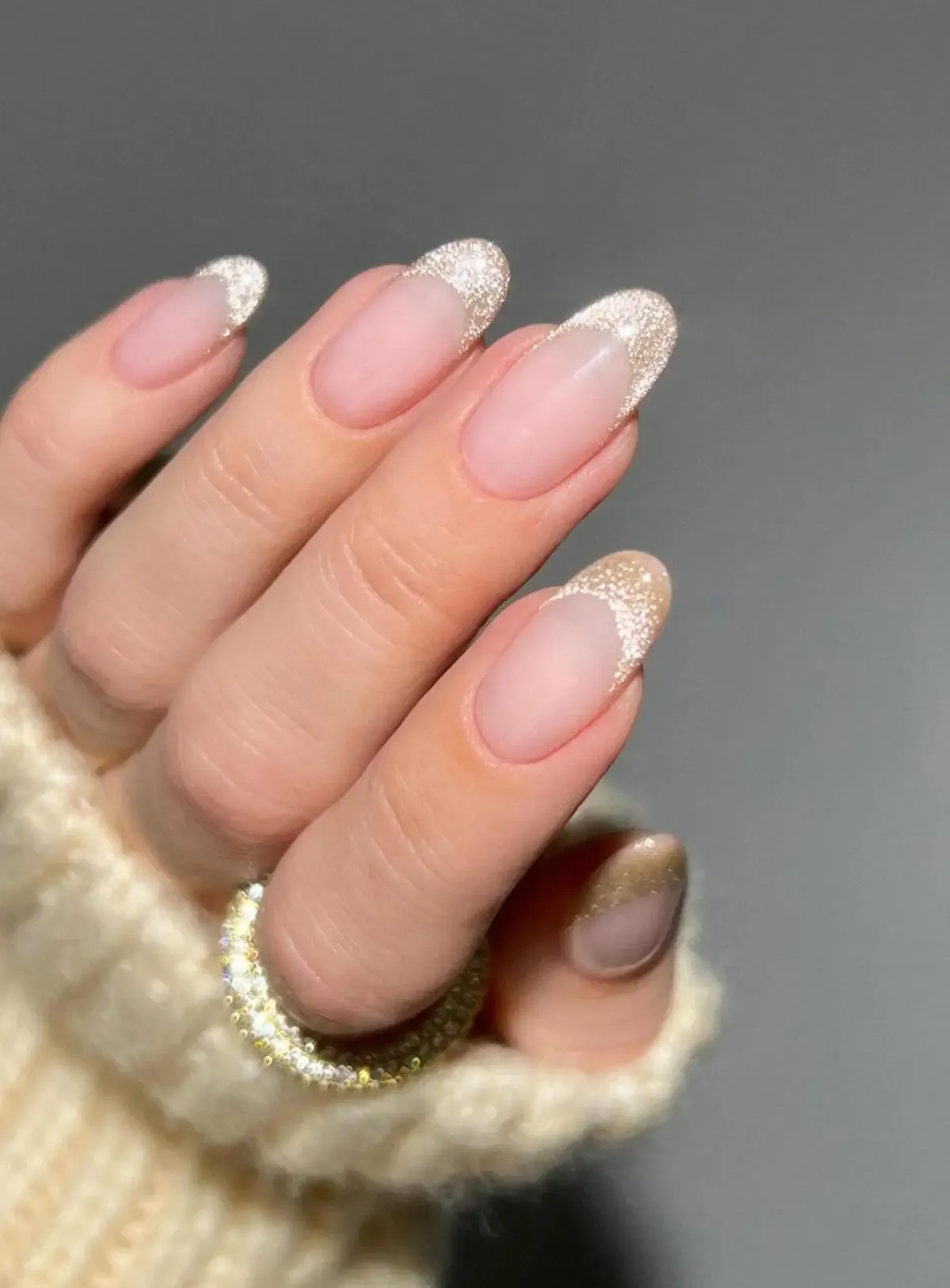 Gold velvet French tip nails.