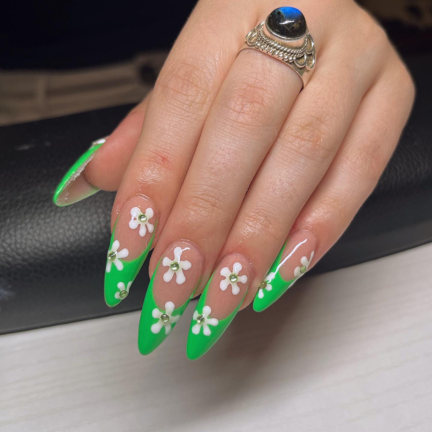 Long stiletto nails look awesome but if you wear a green french manicure with some white flowers, you are sure to bring a summer vibe.