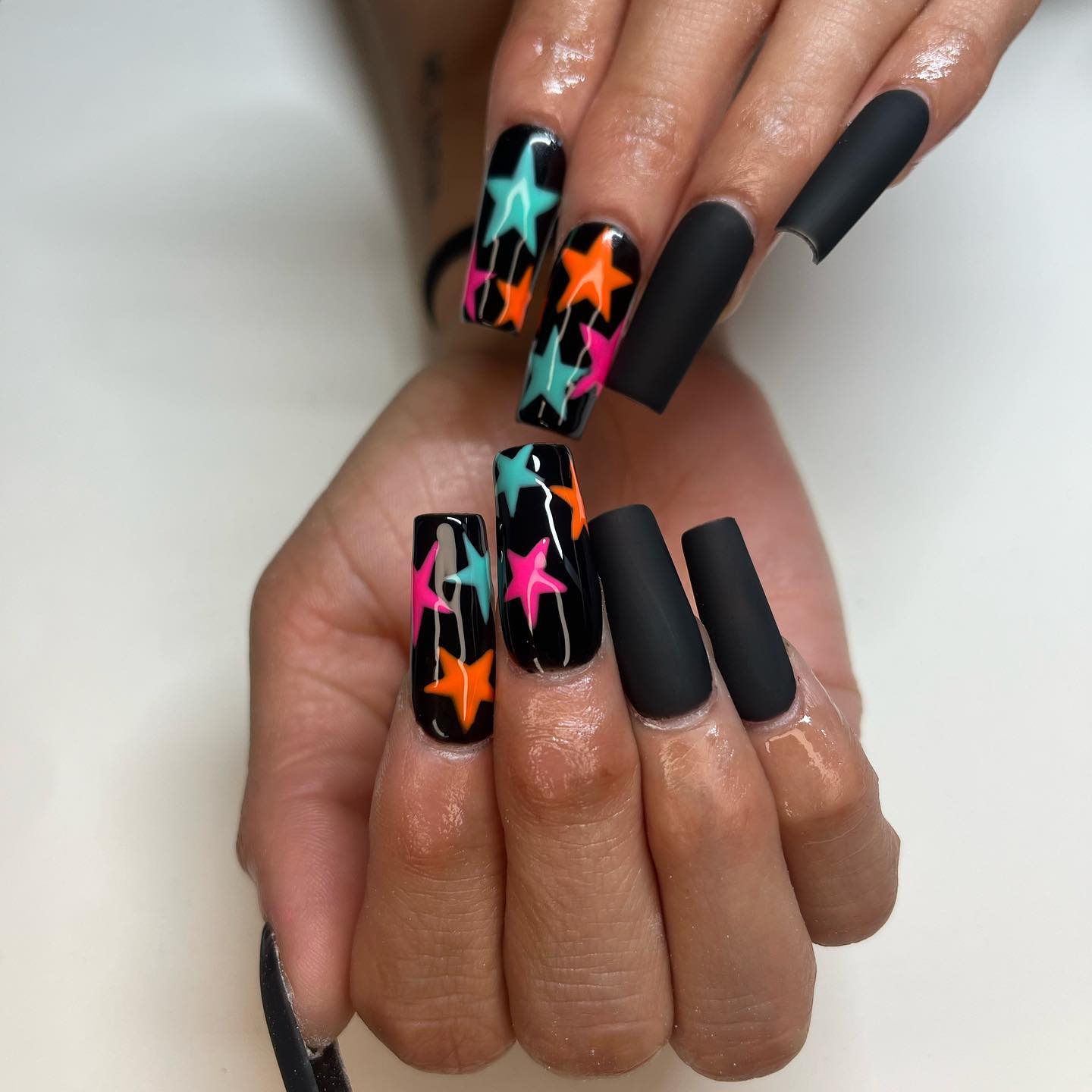 One of the coolest nail desings is definitely black matte look. If you feel like giving them some color, you can wear a nail art of colorful stars.