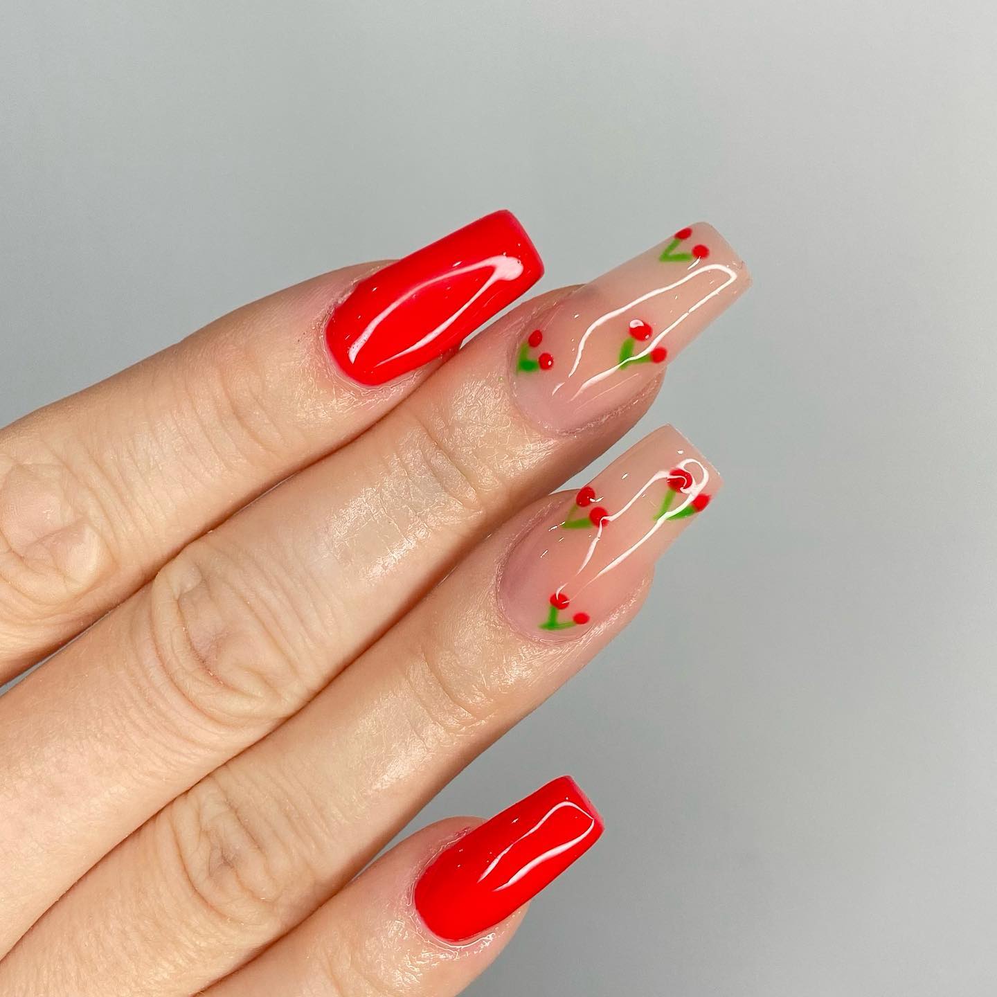 Adding some cute and small red cherries on nude nails is a great idea. You don't have to do it on all of your nails but just two of them.