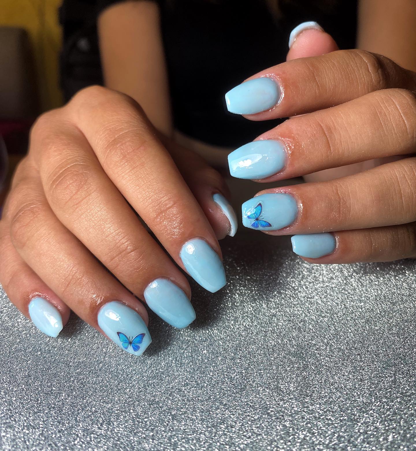 For your short square nails, light blue is a perfect choice. One blue butterfly sticker on each of the ring finger looks so cute, too.