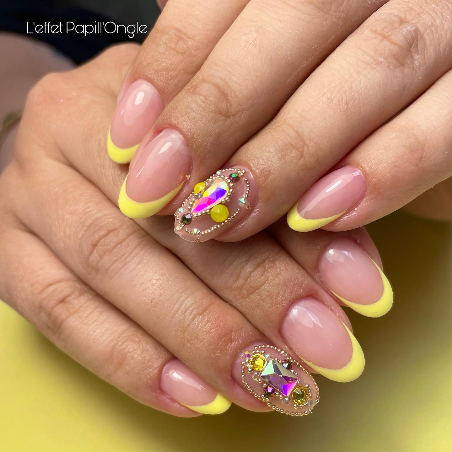 Nails don’t have to be too long to be stunning and bold. Go for a bright yellow if you like cheerful and loud looks, and spice it up with some bright gemstones to get the perfect French manicure.