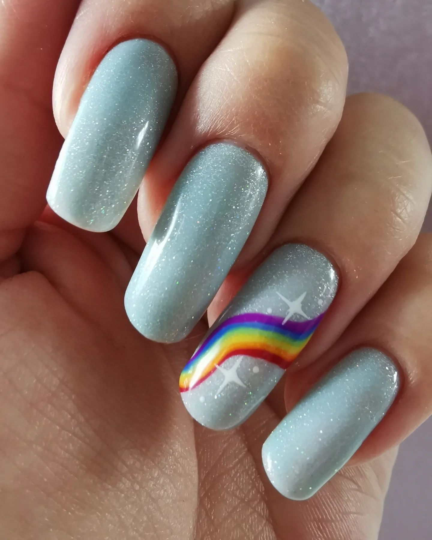 The beauty after the storm: Rainbow! It is full of color and it represents a sign of hope. You should go for it with your light blue nails.