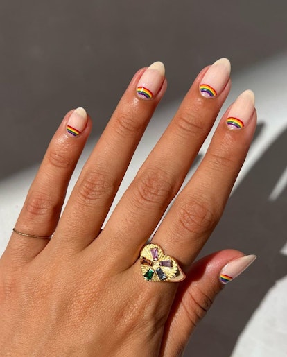 Retro rainbow half moon details on short almond nails are on-trend for 2024.