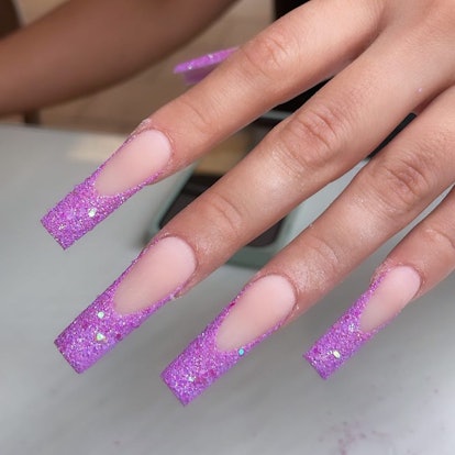 Purple glitter French tip nails are on-trend.