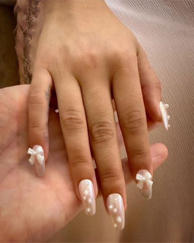 <p>Tom Bachik Instagram</p> Bow nails on Camila Cabello by Tom Bachik.