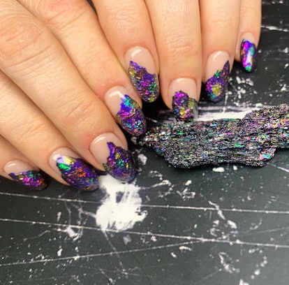 Purple gemstone designs on short almond nails are on-trend for 2024.