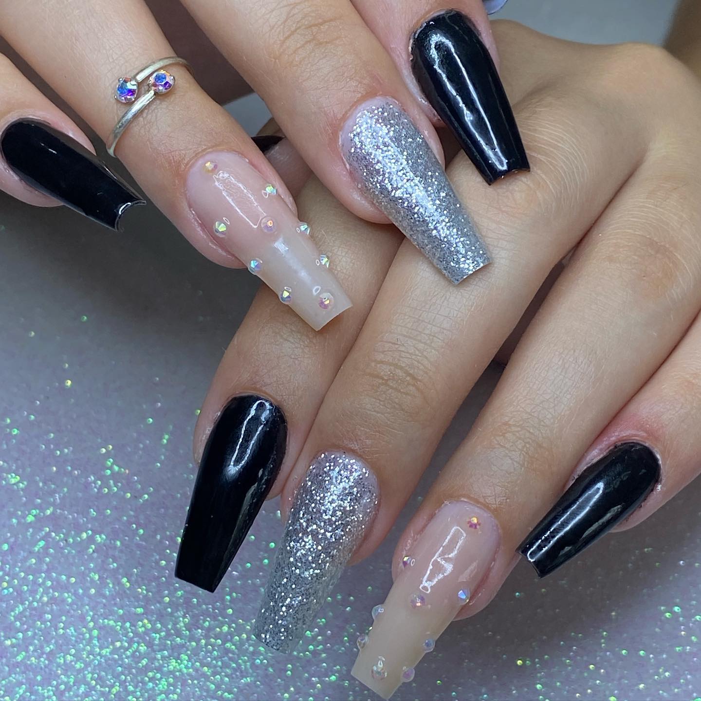 Why not having fun with your nails while looking chic with them? Black, silver and nude polishes go well with each other in this design. It's a perfect balance for everyday wear.