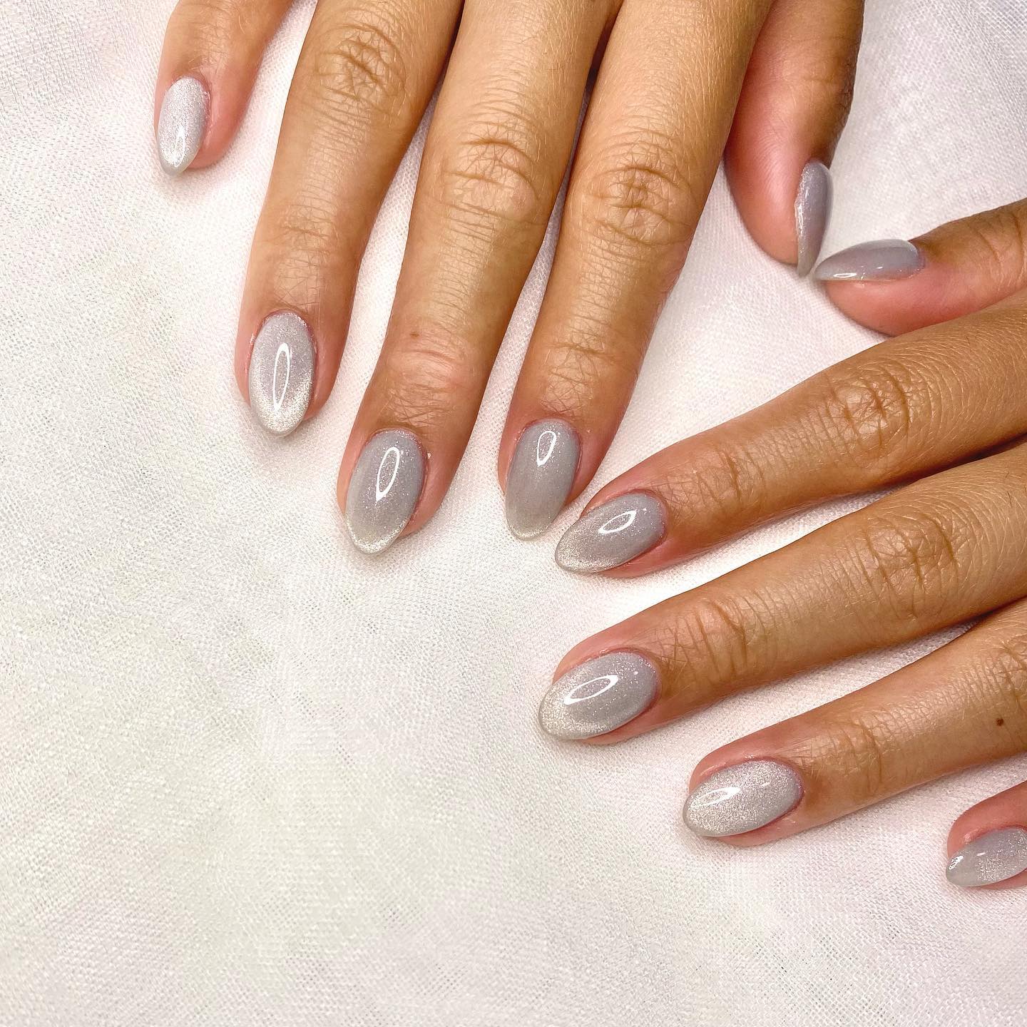 Grey is a neutral color between black and white. To make this color look gorgeous, you should try this cat eye nail art.