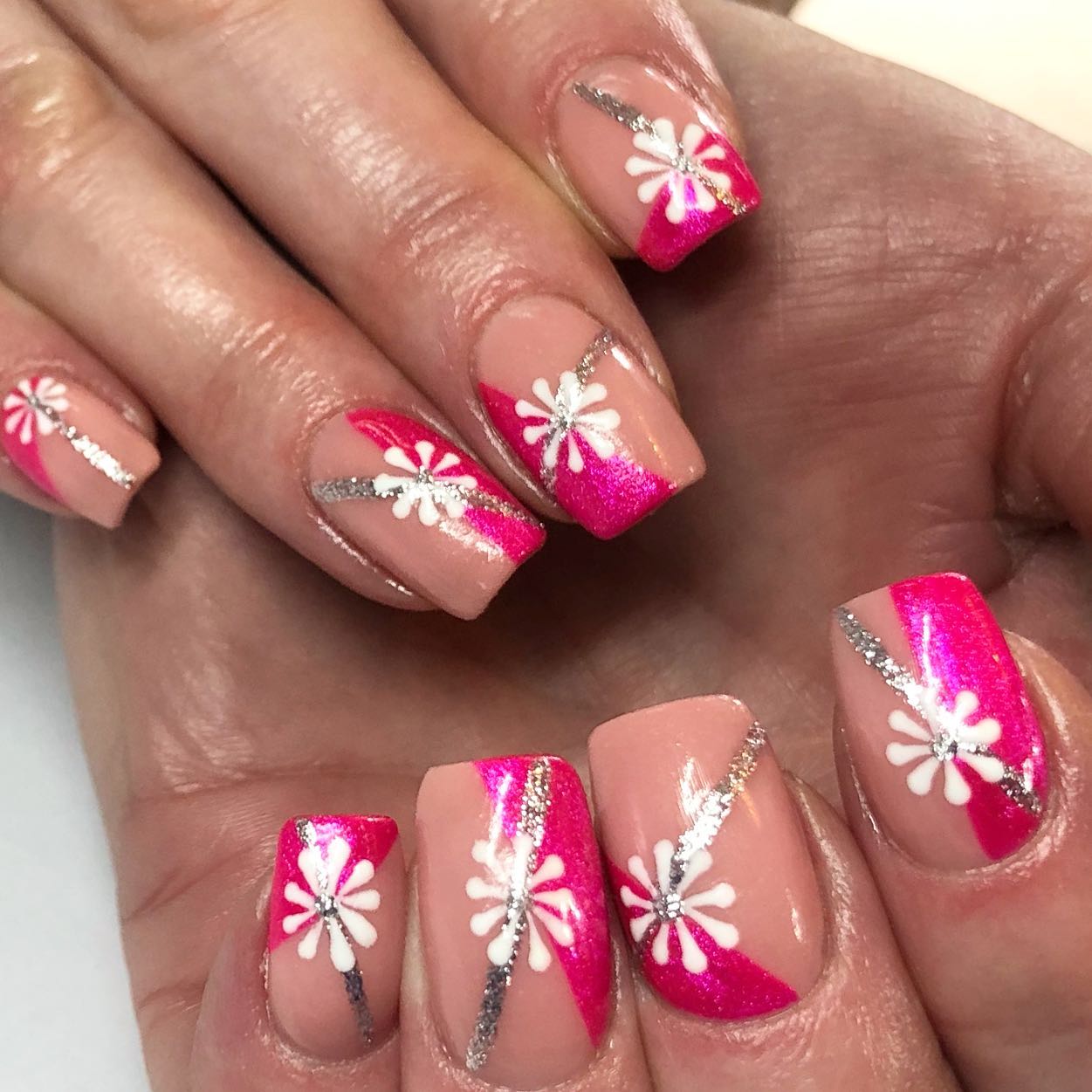 Geometric daisies with a silver glitter and dark pink nail art are quite spectacular. If you want everyone to notice you, go for this nail design.