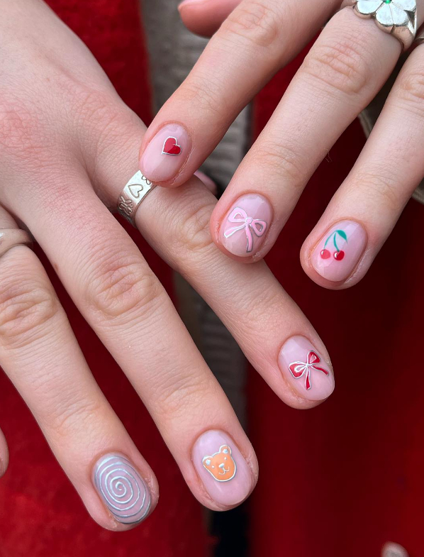 mismatched nail art with bows and cherries