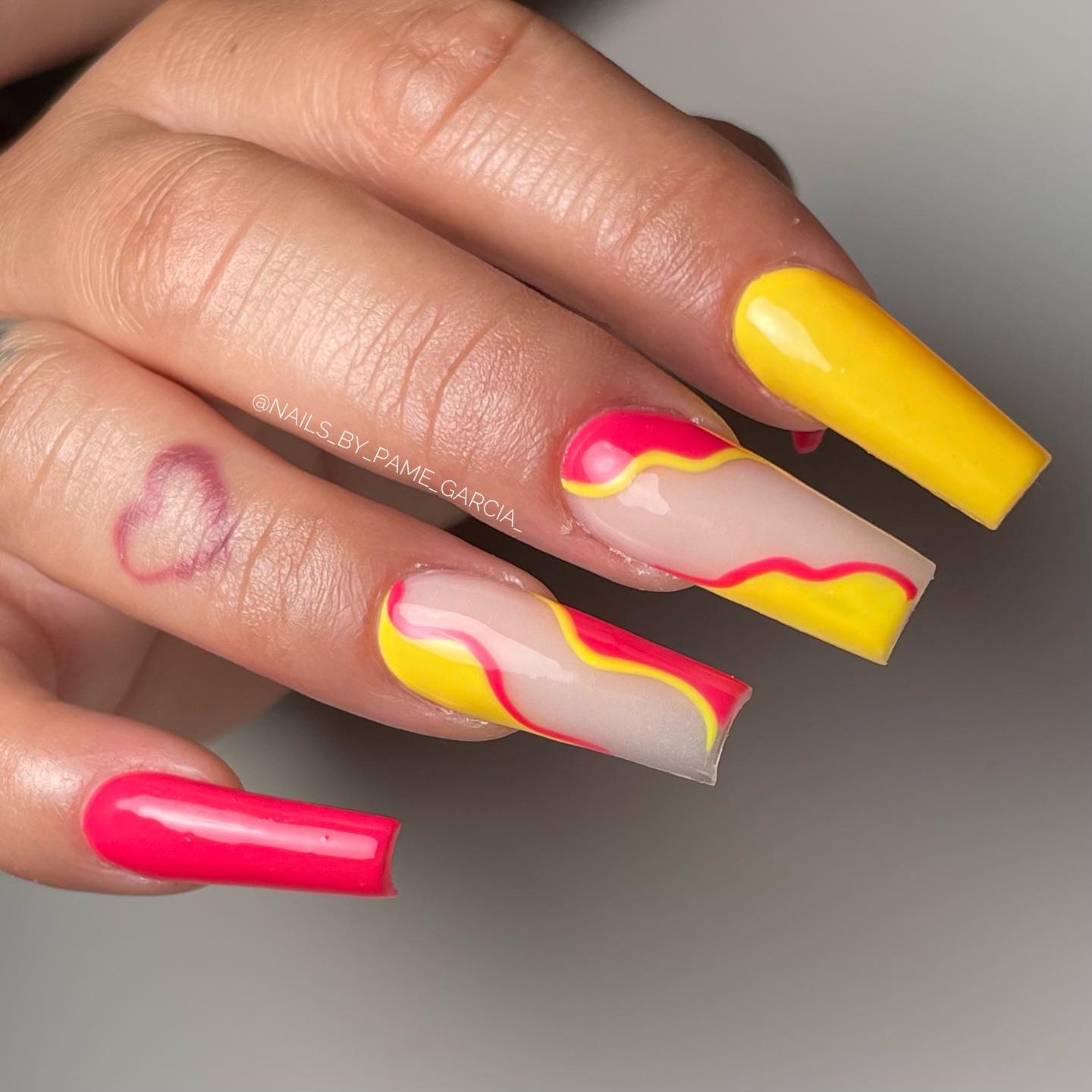 Those who like swirl nail designs will adore this. Mixing yellow and pink with swirl nails is a great idea.