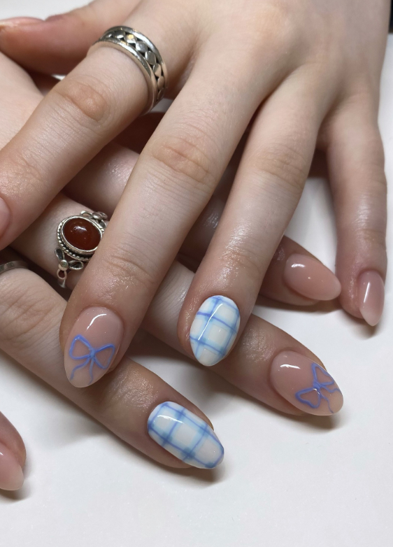 nude and blue bow nail design