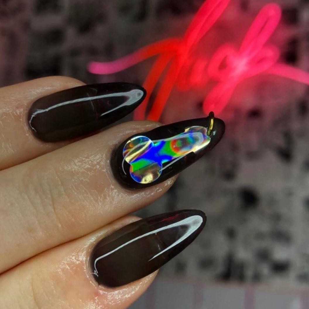 A pierced nail is a super-cool way to show off your nails. How about a holographic penis nail art? Wow, it's an another level.