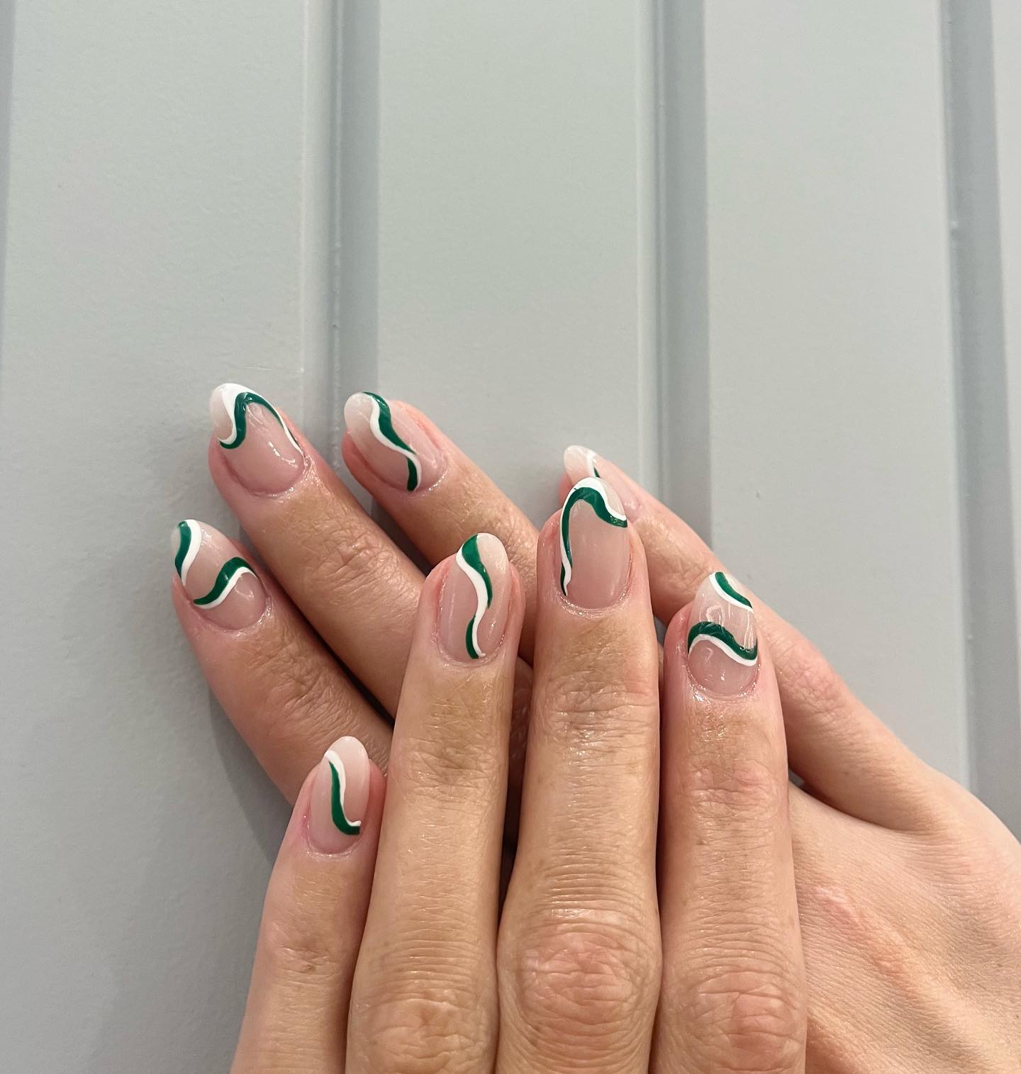 Dark green is a color that not many people choose to apply on their nails, but what about green swirls? These will help you achieve a cool look.