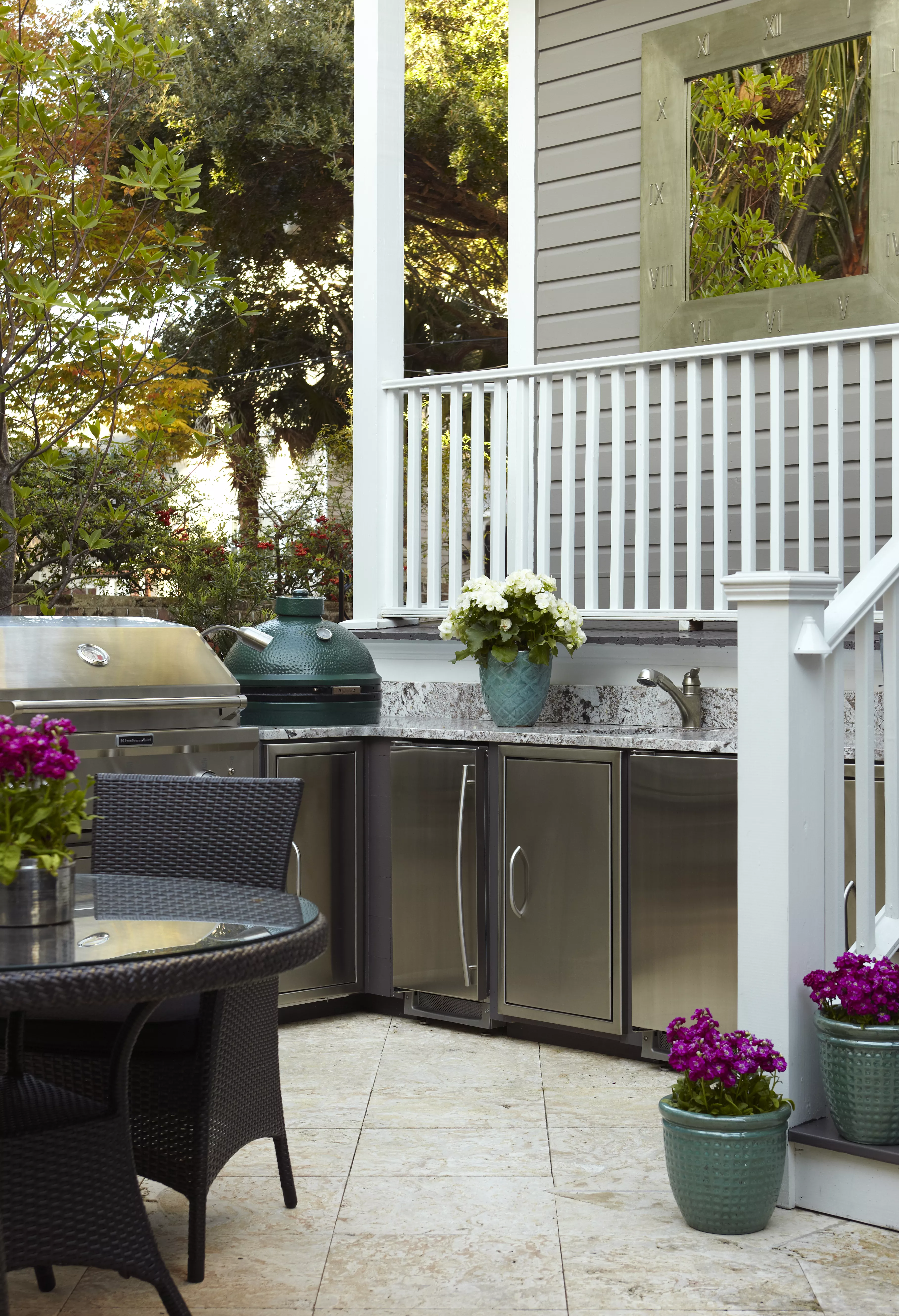 Patio grill with stainless steel cabinets underneath sink and countertop