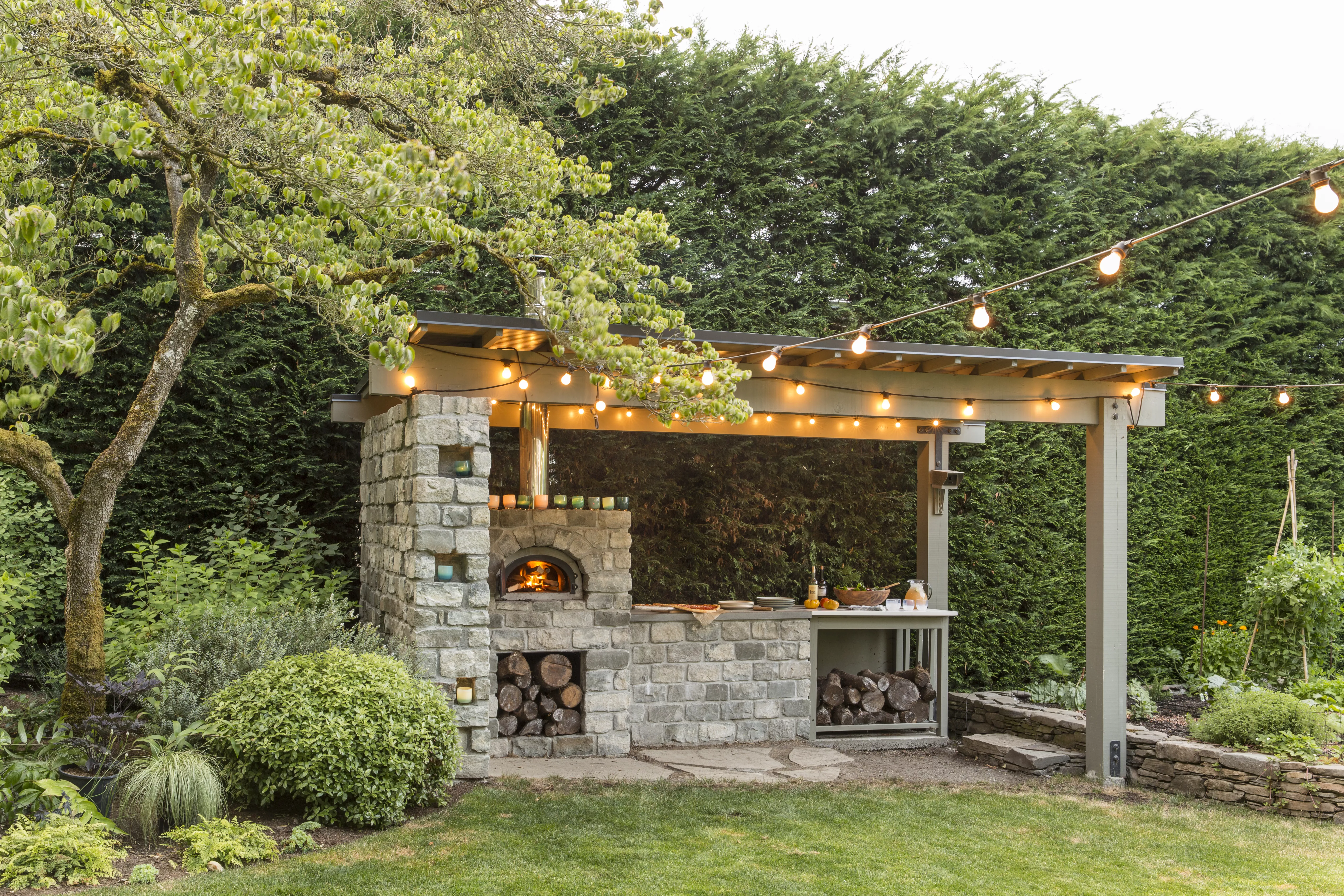 Outdoor covered kitchen with a wood fire oven