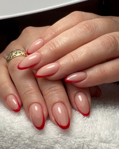 Red micro French tip nails are trending for Aries season 2024.