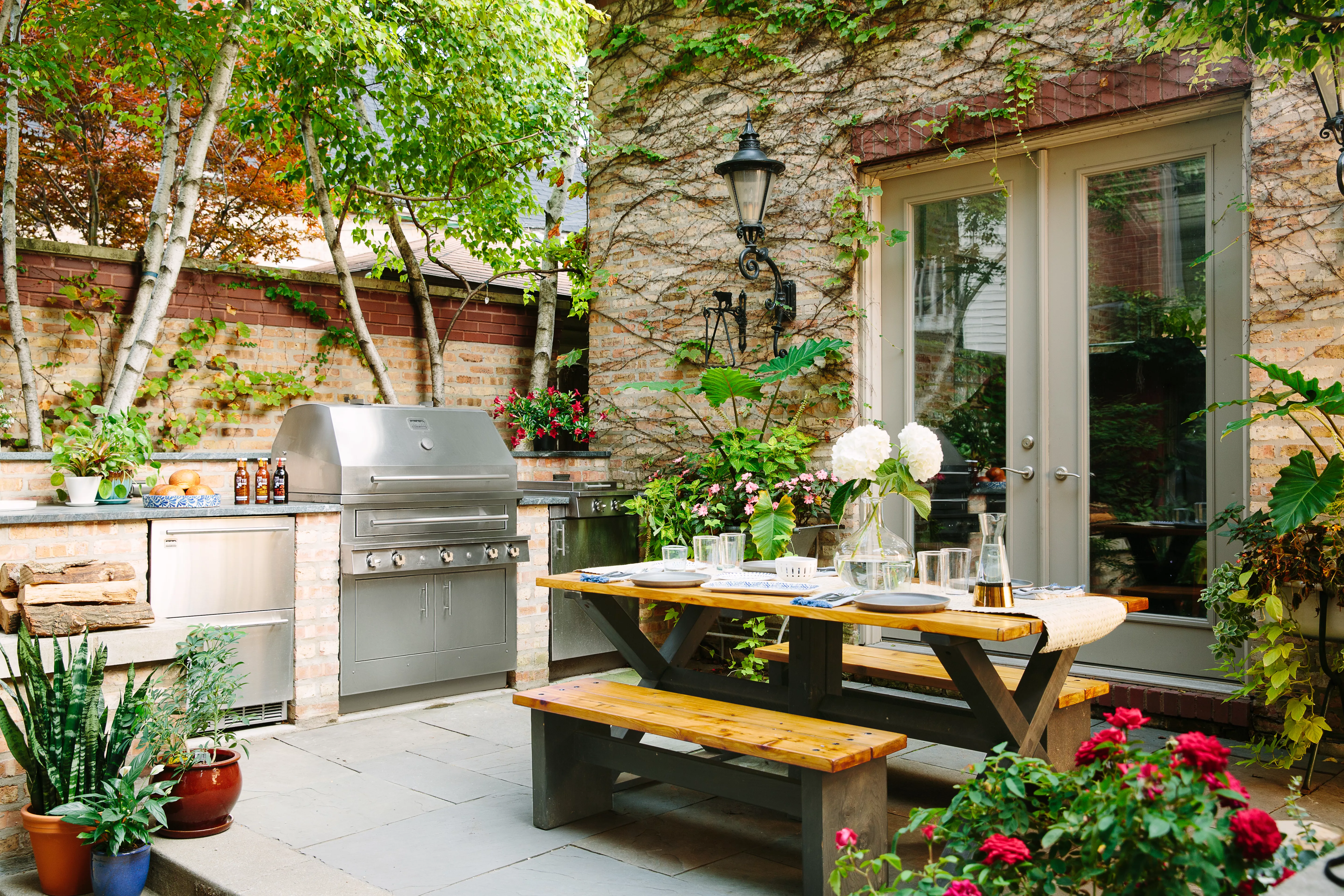 Outdoor kitchen and dining area on patio. 