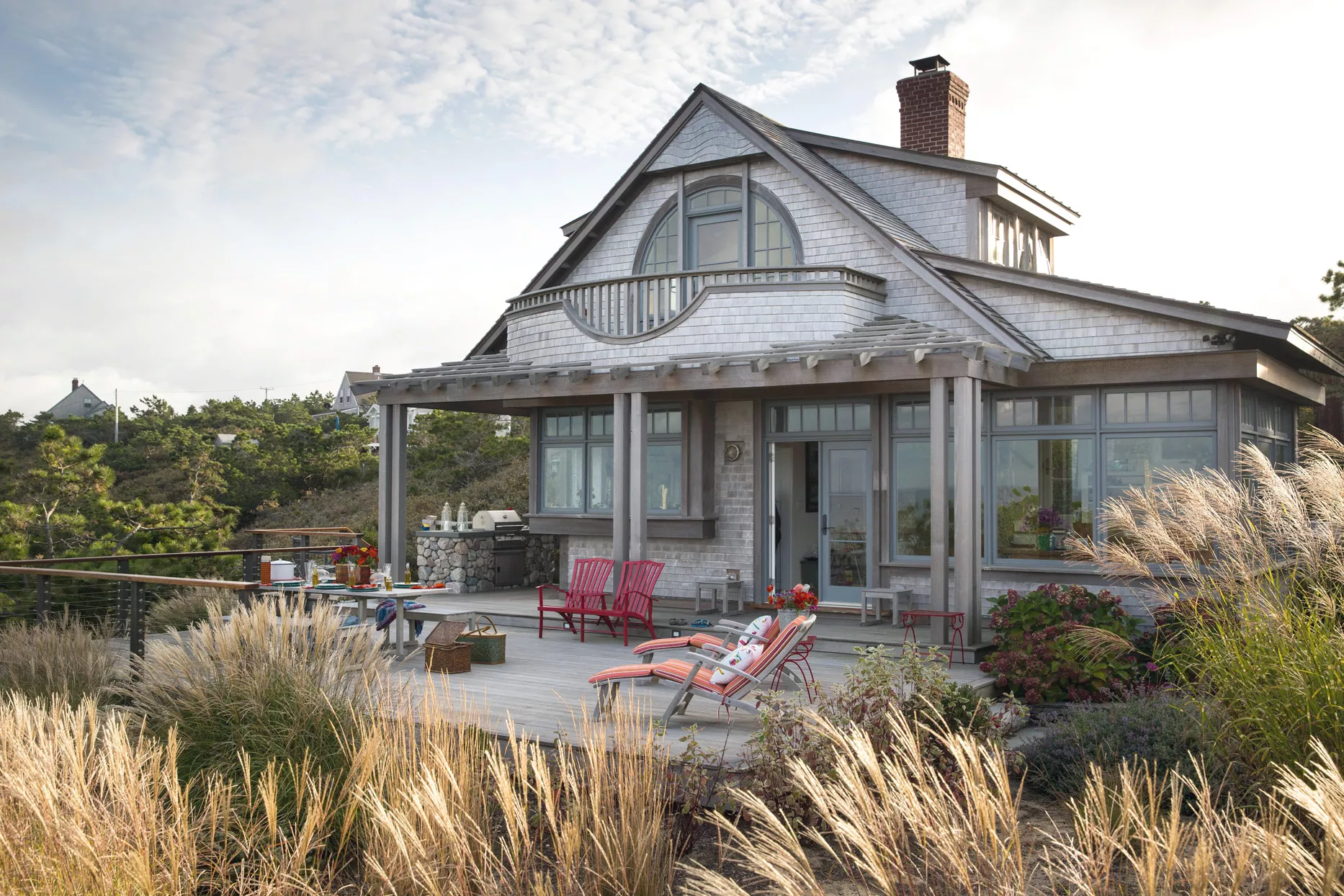 Two story beach house with grey shingle siding