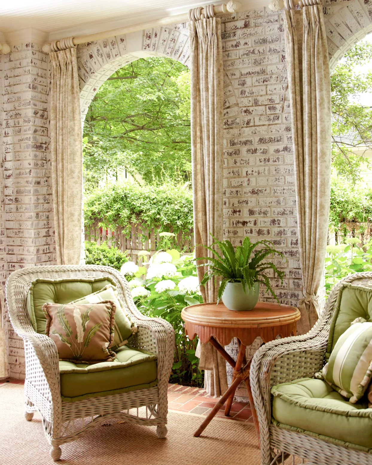 brick covered patio with curtains