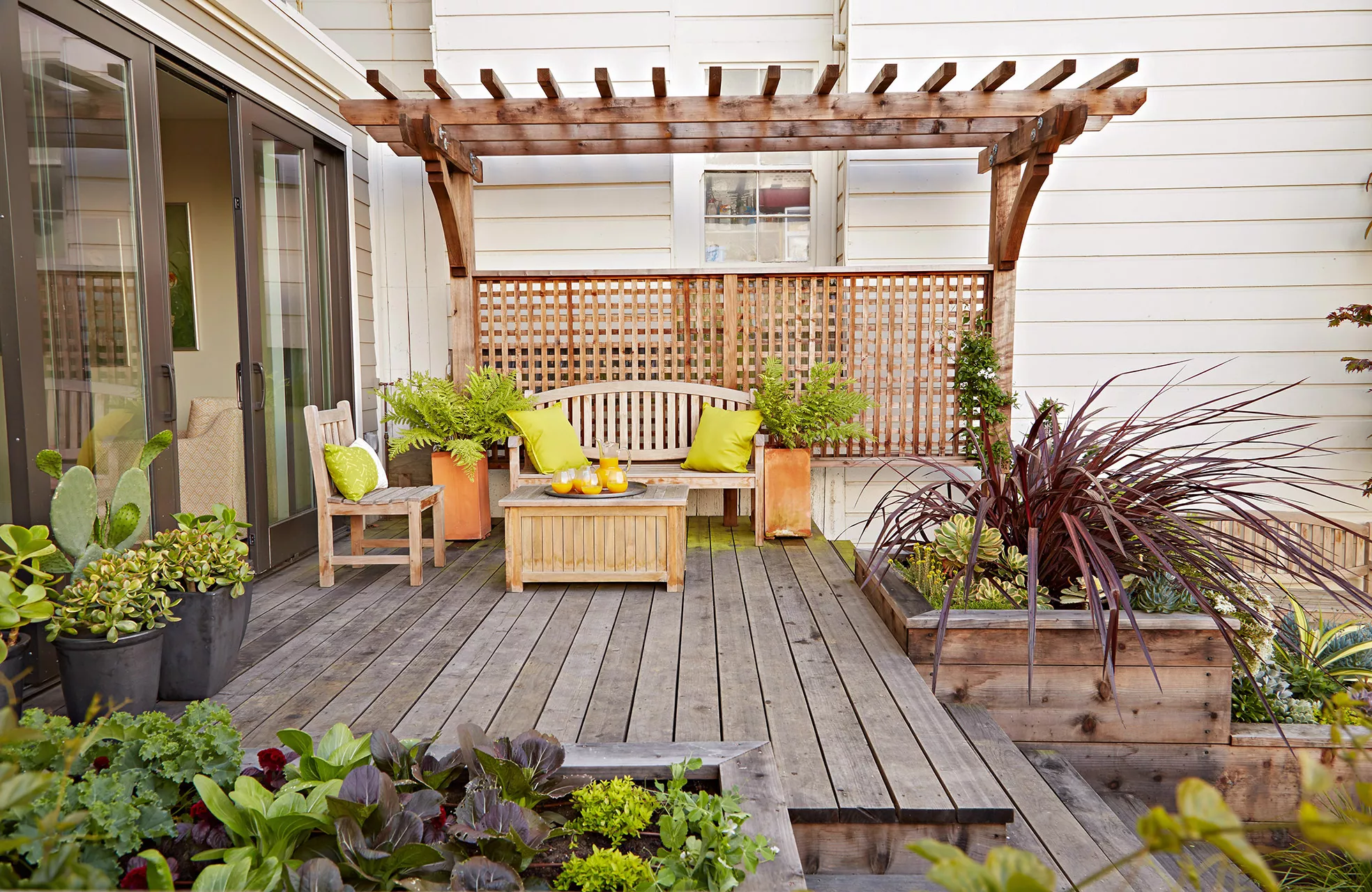 wood deck seating area with raised garden beds