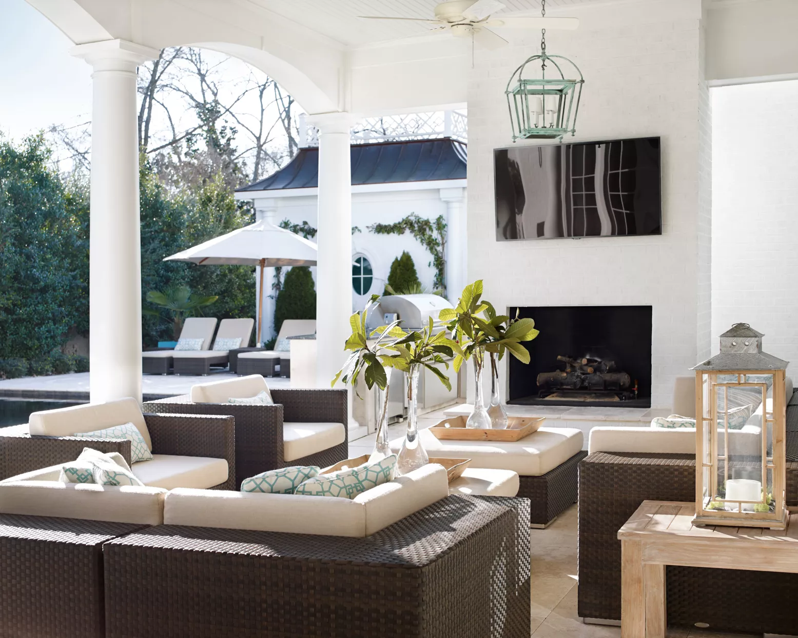 flat screen tv and fireplace in covered patio