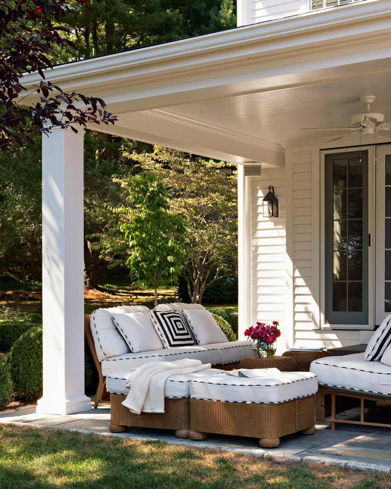 flushed covered patio with white furniture cushions