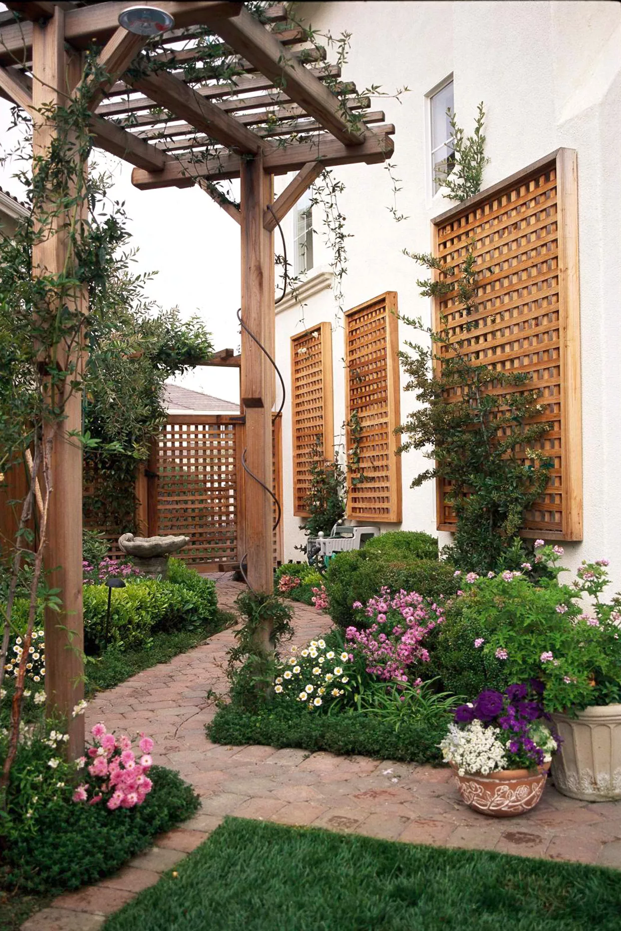 wood garden pergola with winding brick path