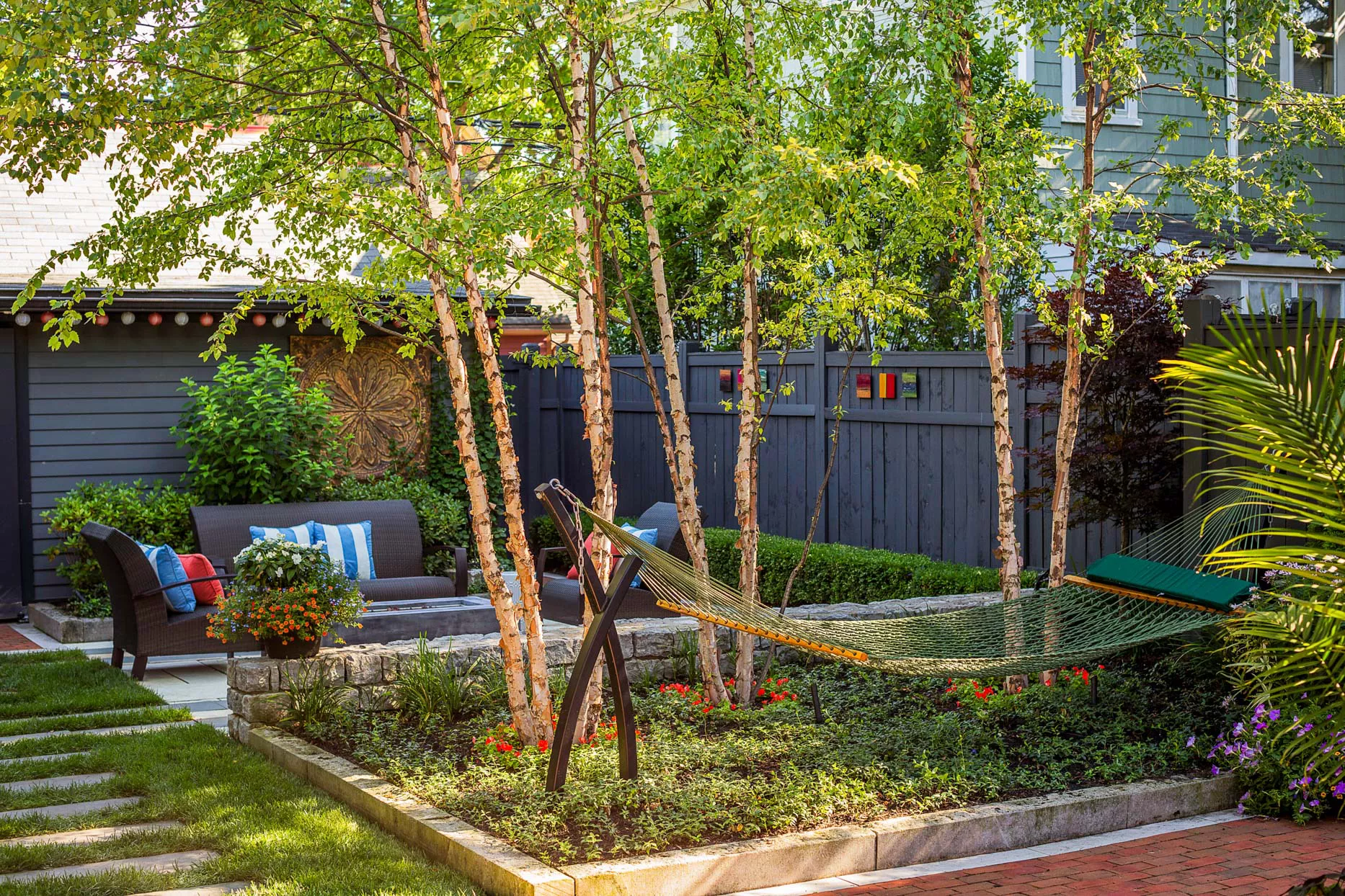 hammock hanging in manicured backyard