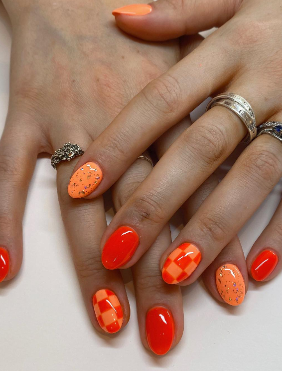 mismatched neon orange nails with checkered print