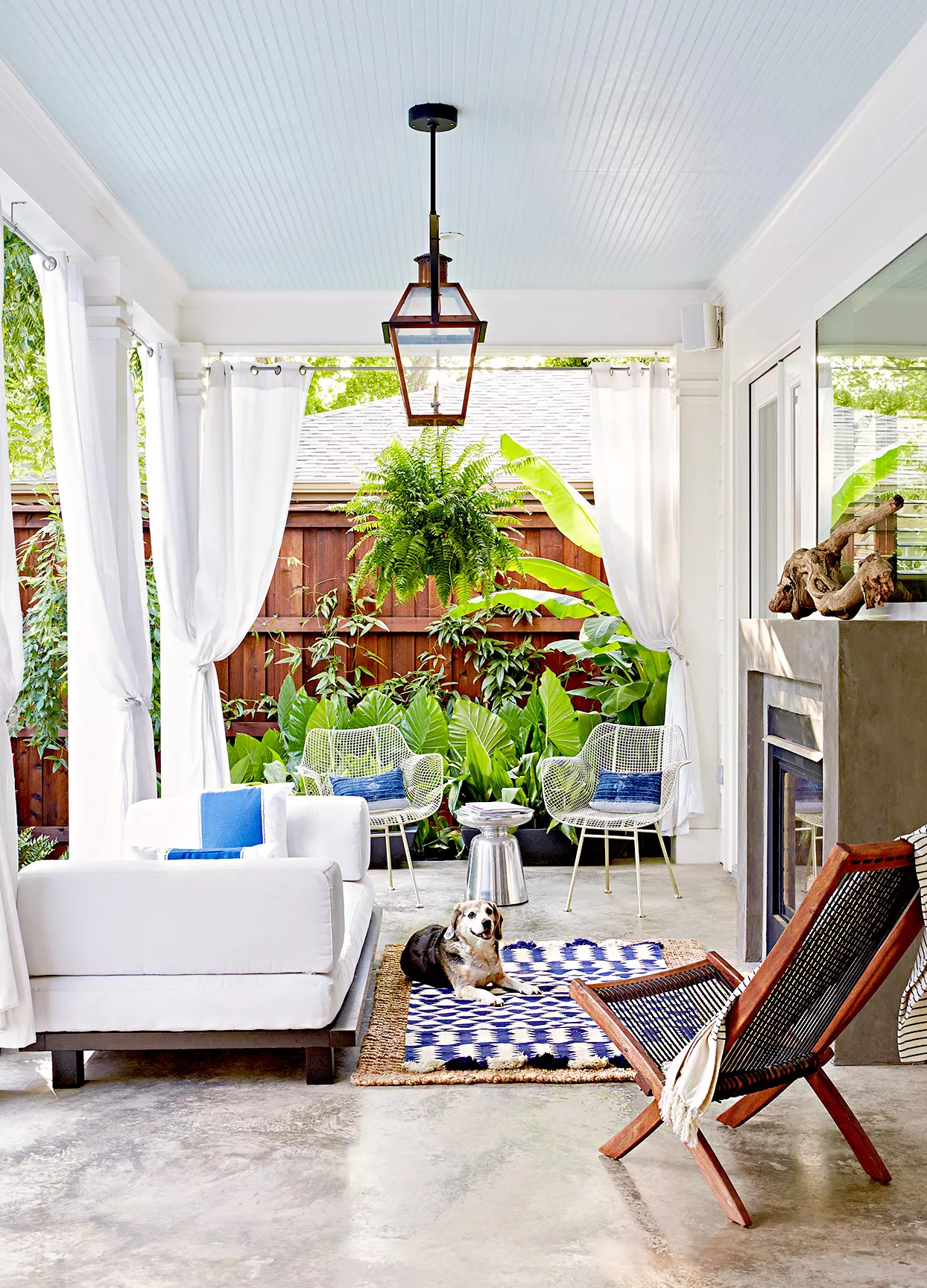 Porch with couch, curtains, dog