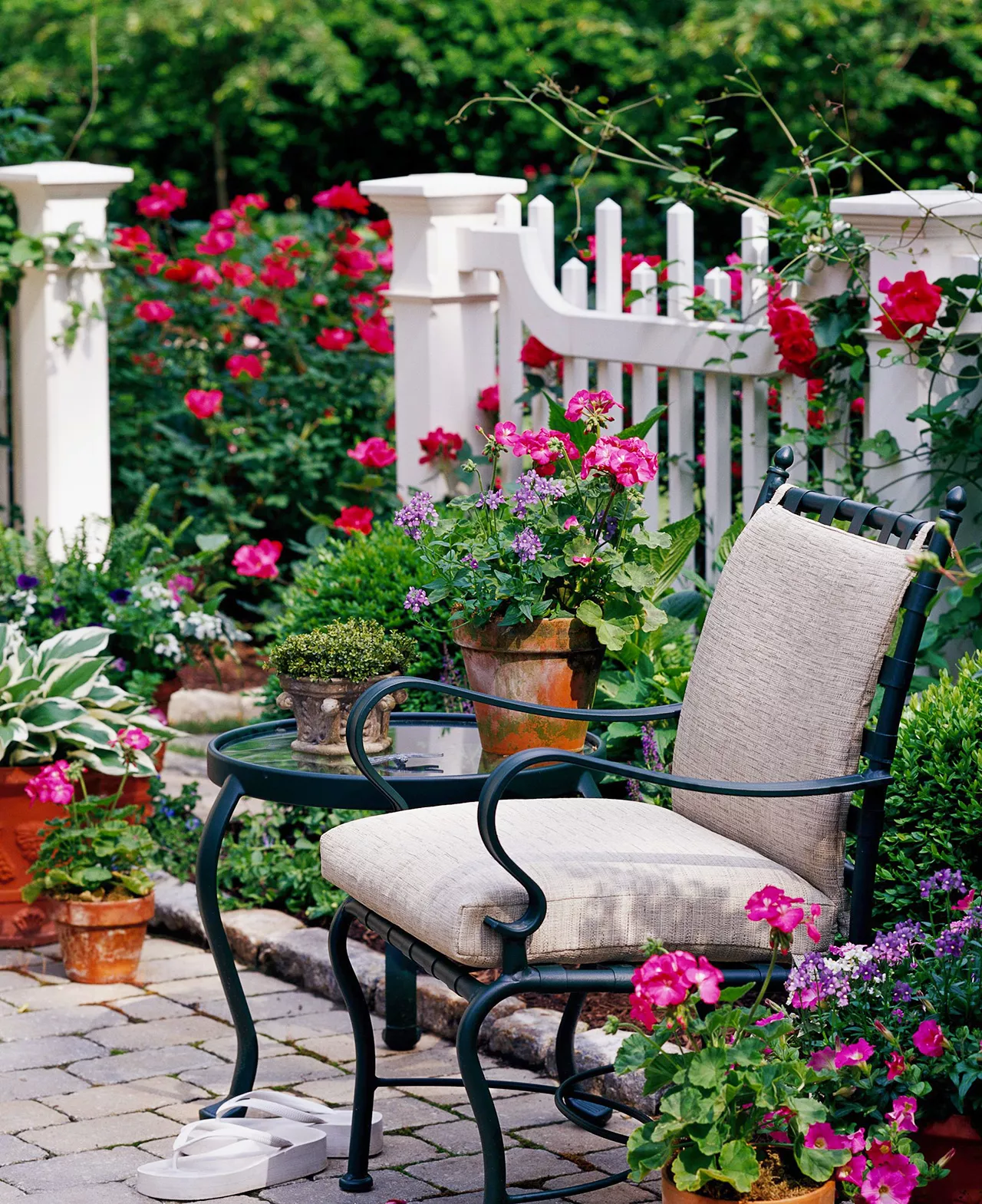 seating area along white fence flower garden