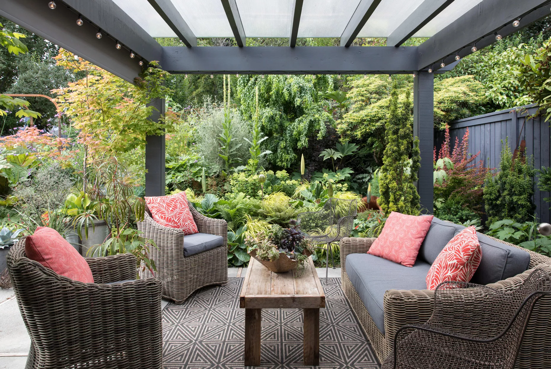 wicker outdoor furniture and red pillows