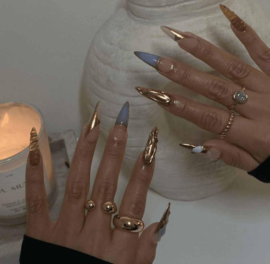 Obsessed with gold? This post will feature 99+ gold nail ideas that are foolproof gold nail designs that drip with luxury. Whether you’re getting ready for a wedding, party, birthday, or just want to feel like a million bucks, we’ve got the perfect gold nail design for you.