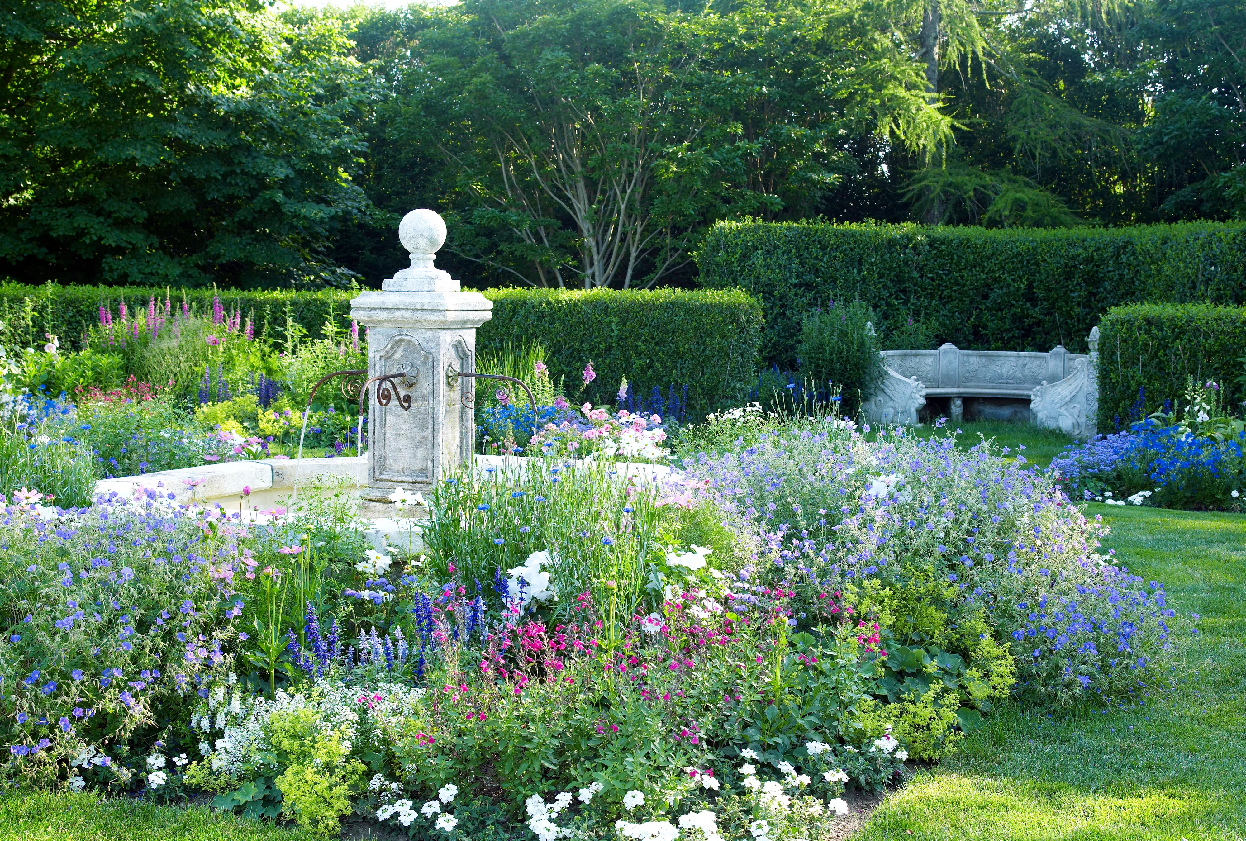 blooming English garden design with fountain 