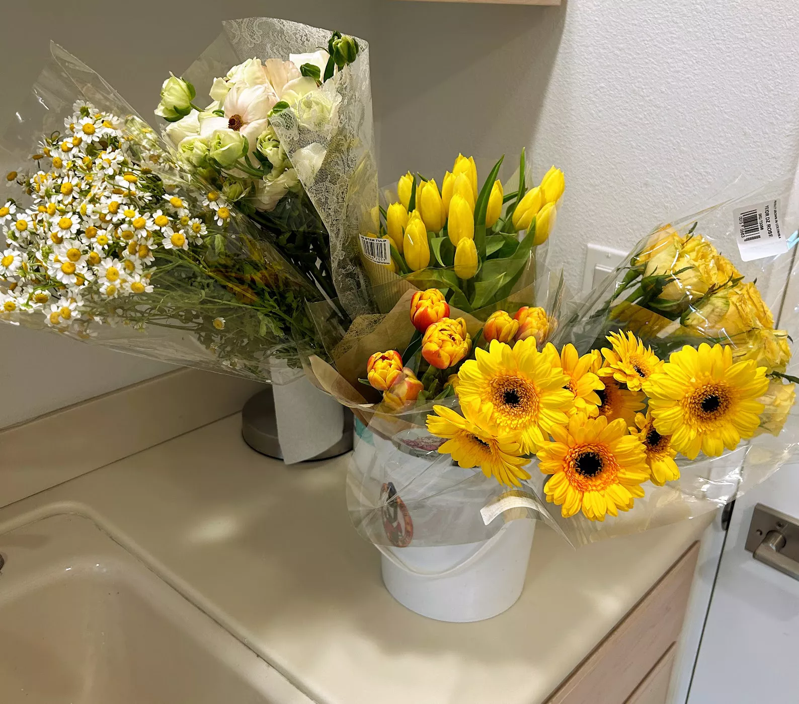 yellow bouquets of flowers on kitchen counter