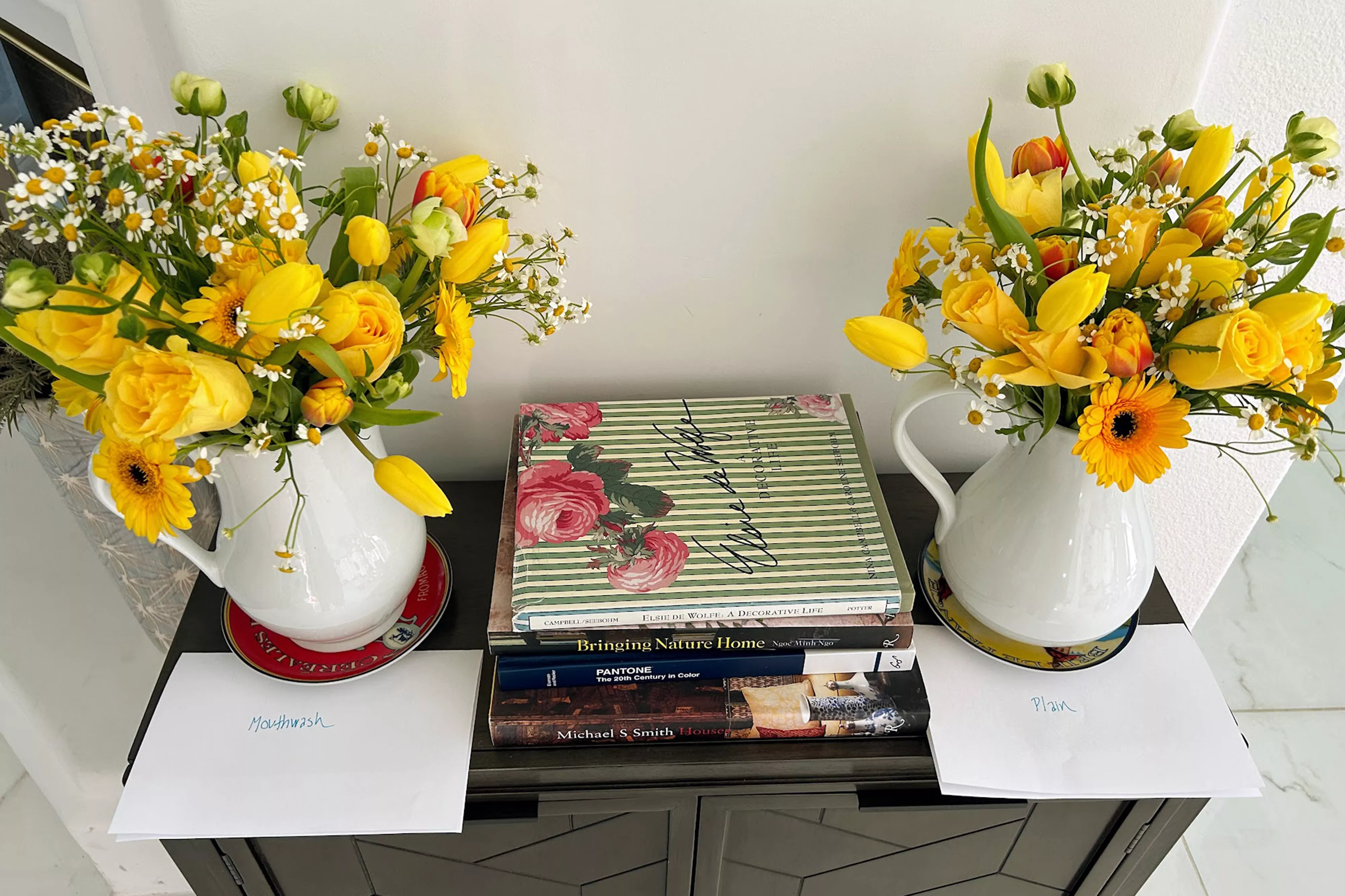 two yellow floral arrangements, one with mouthwash label and other with plain label