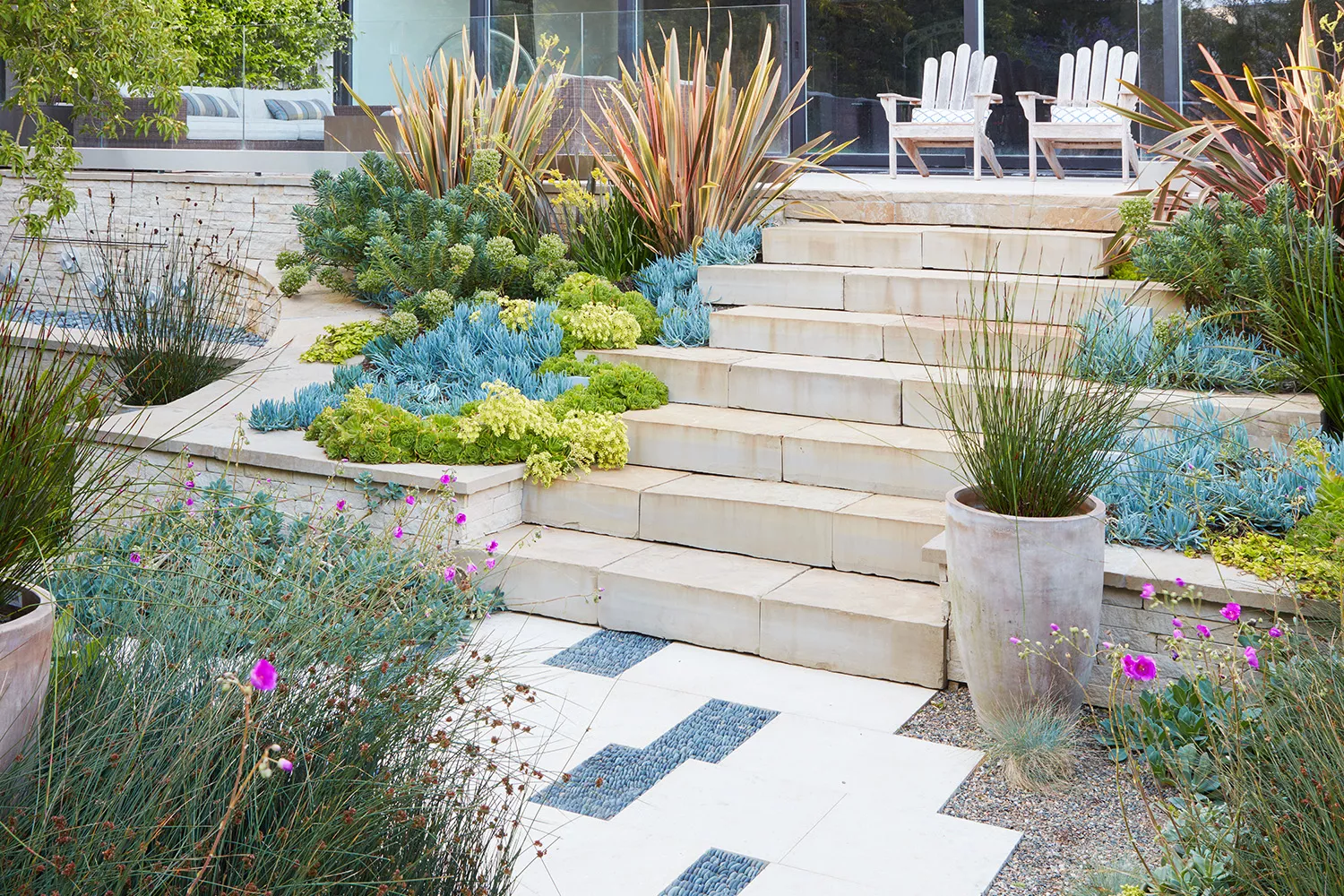 Patio with corner gardens and stone stairs