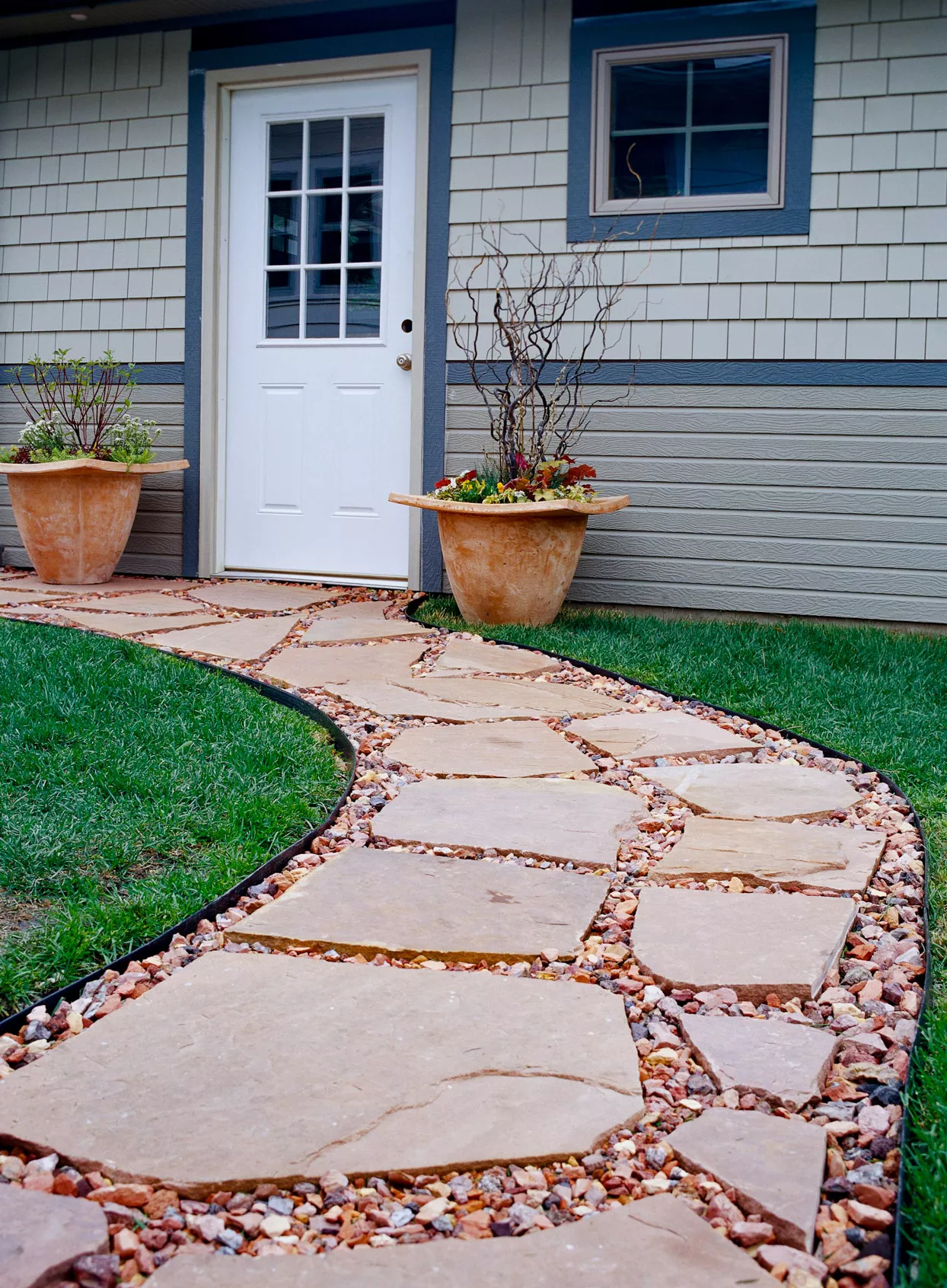 Flagstone Pathway to blue and gray house