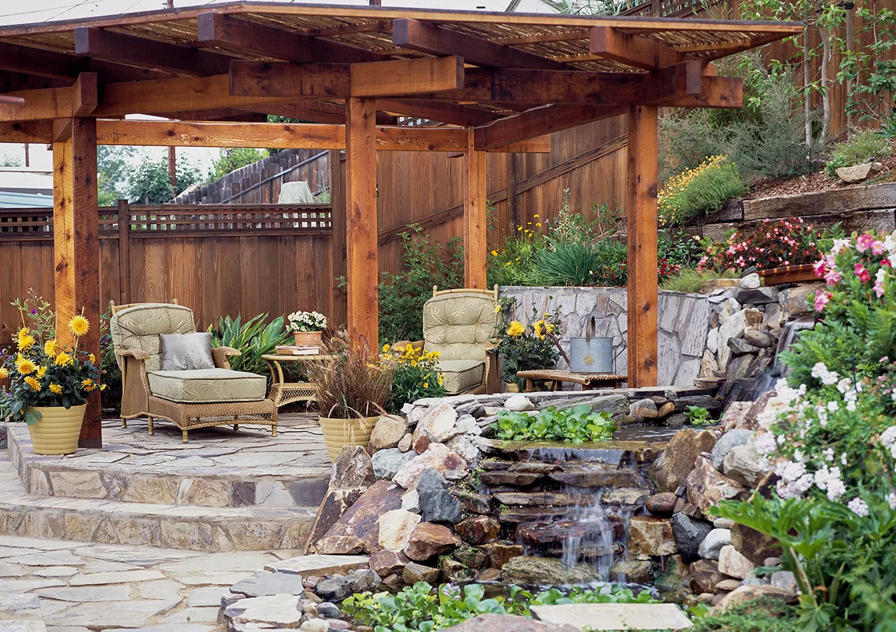 flagstone patio sitting area with garden stream