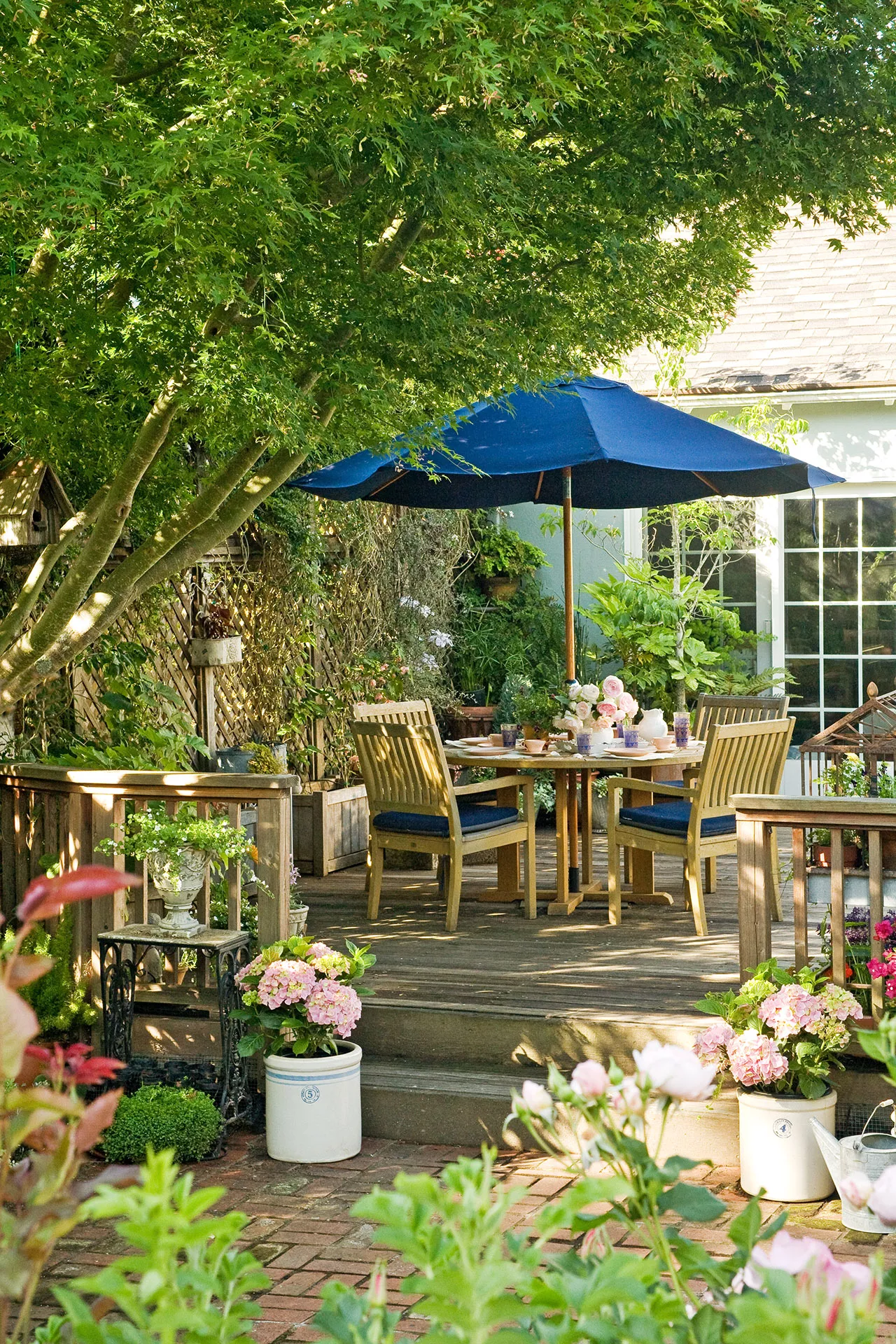 raised wooden deck shade blue umbrella