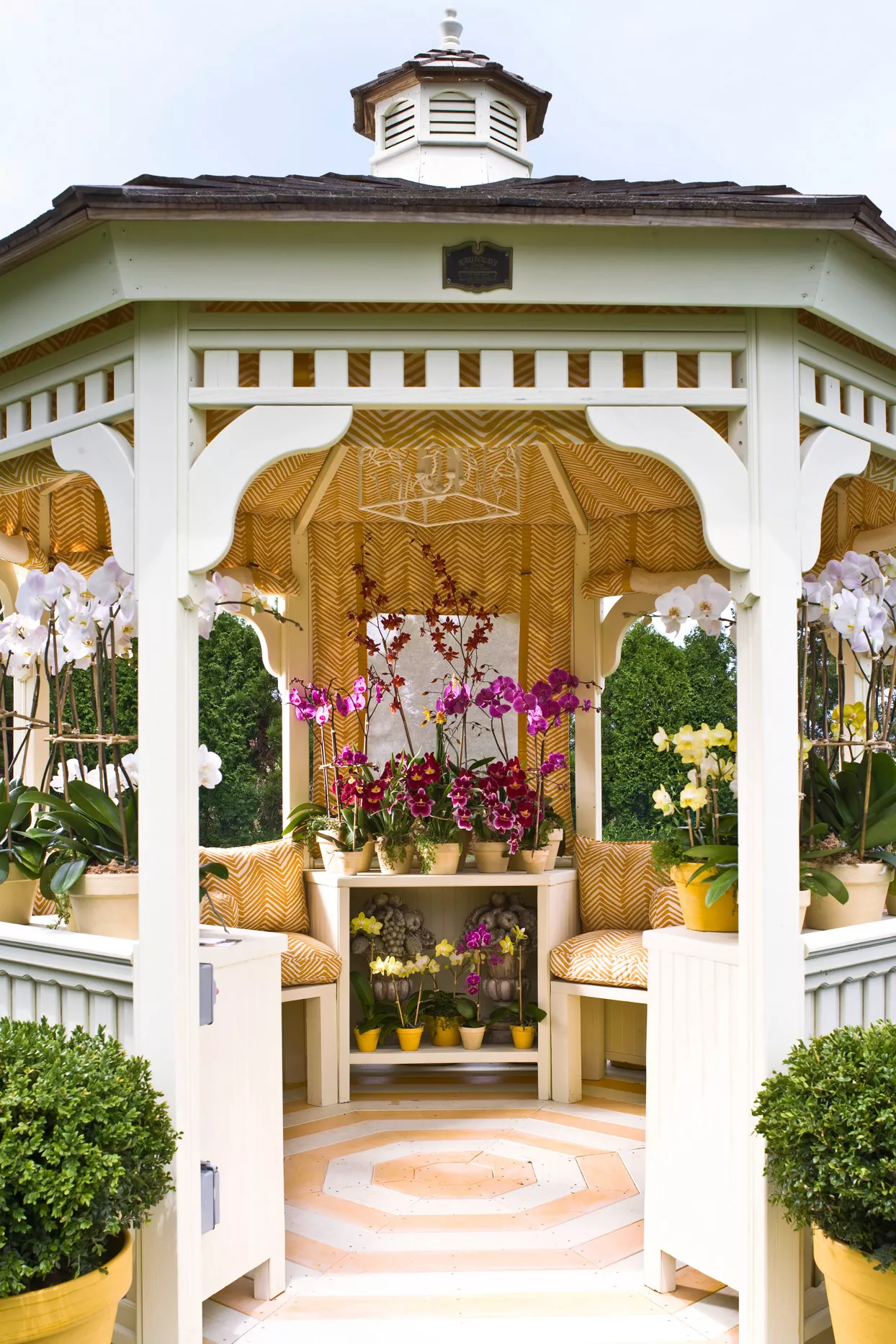 victorian gazebo with yellow seat cushions