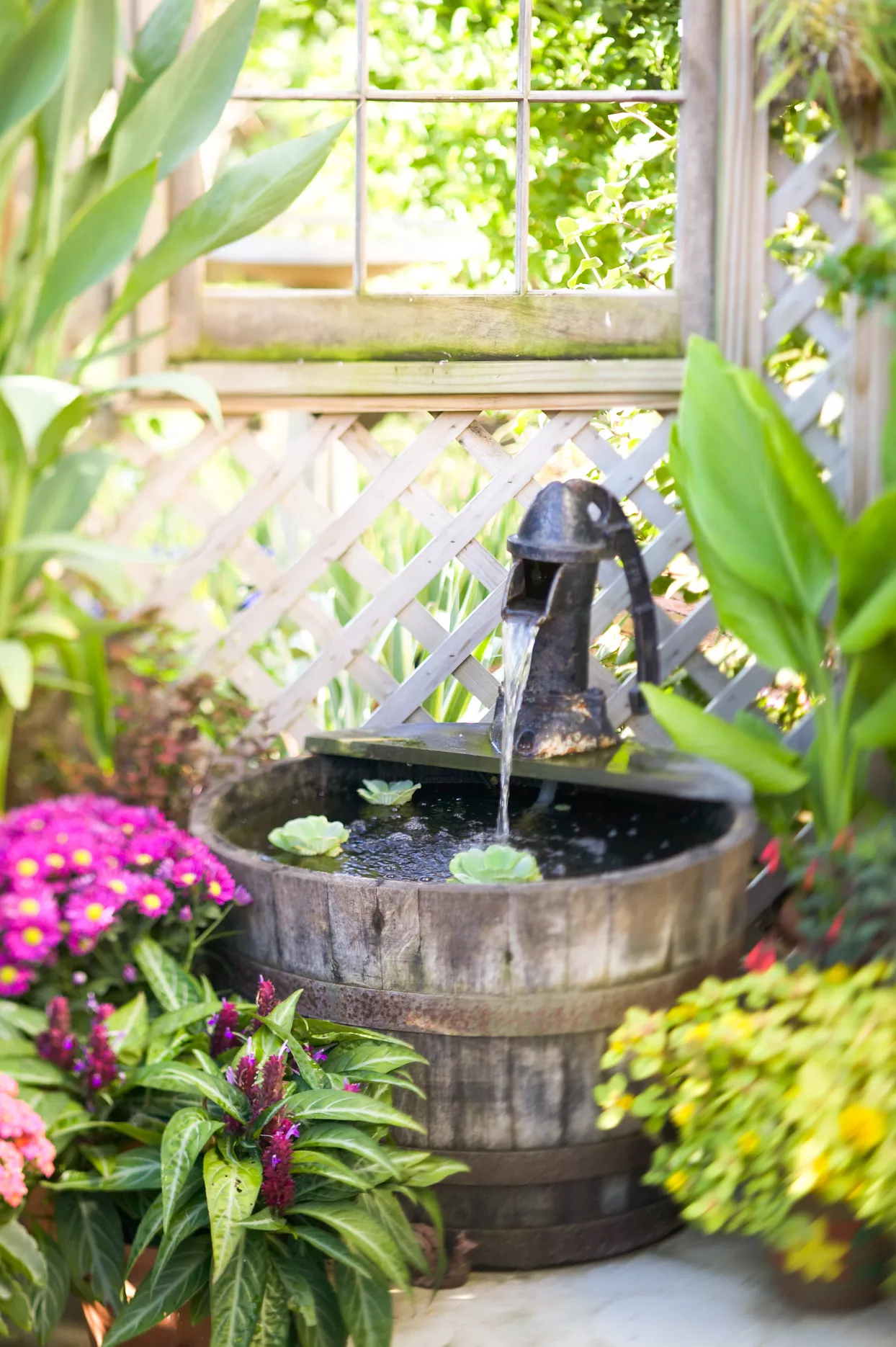 water pump fountain and wooden bucket