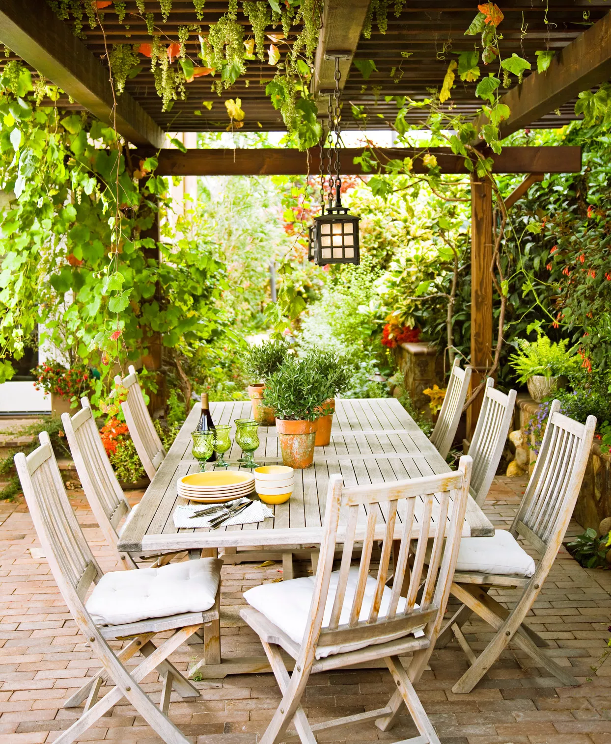 white wooden outdoor seating under pergola