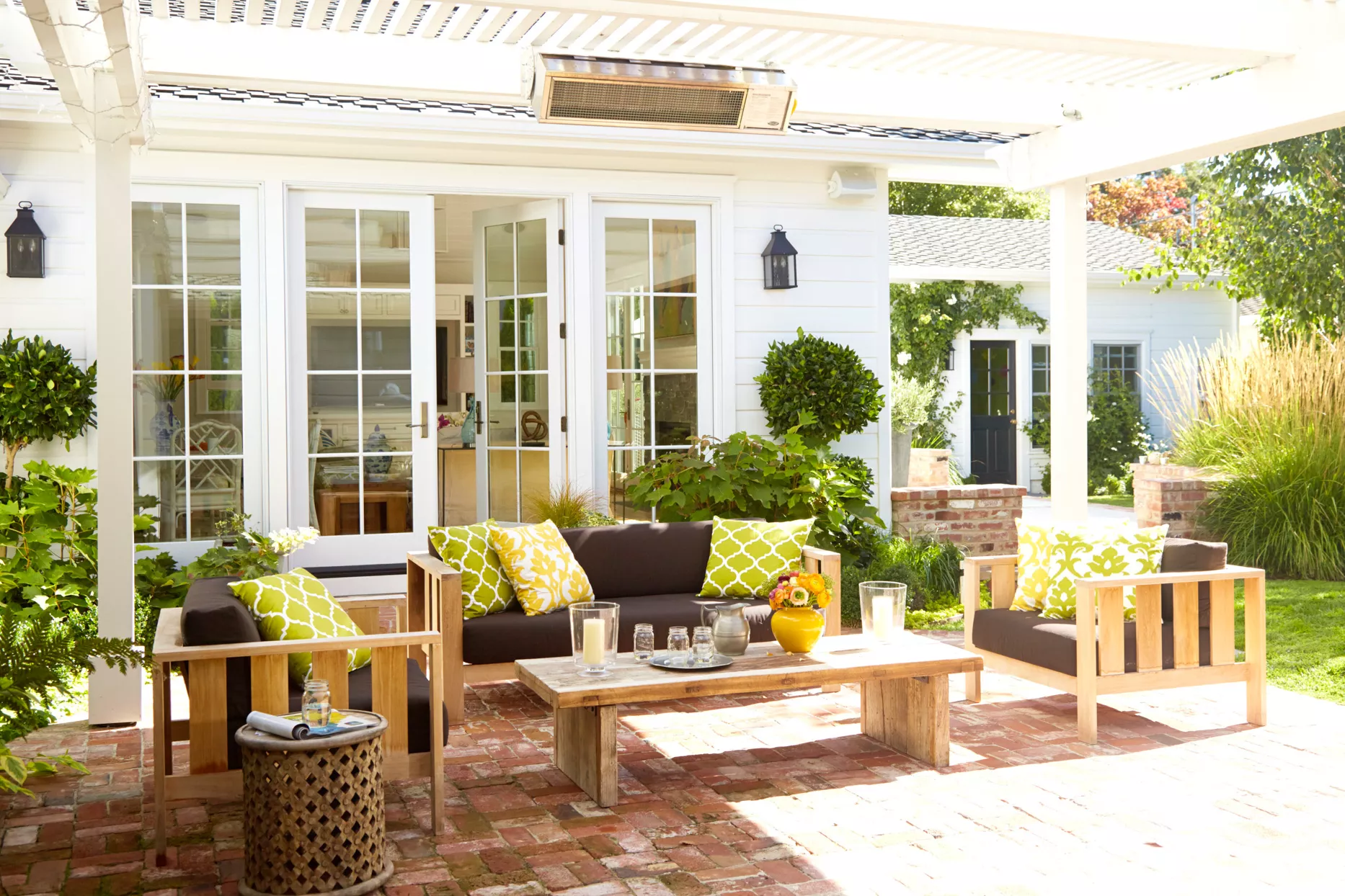 wooden outdoor furniture on brick patio