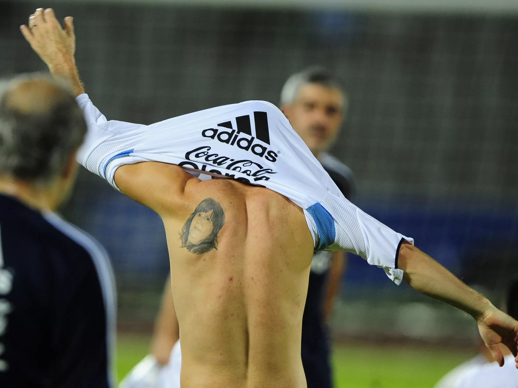 A tattoo is seen on Argentine footballer Lionel Messi's back following a training session at the Bangabandhu National Stadium on September 5, 2011.